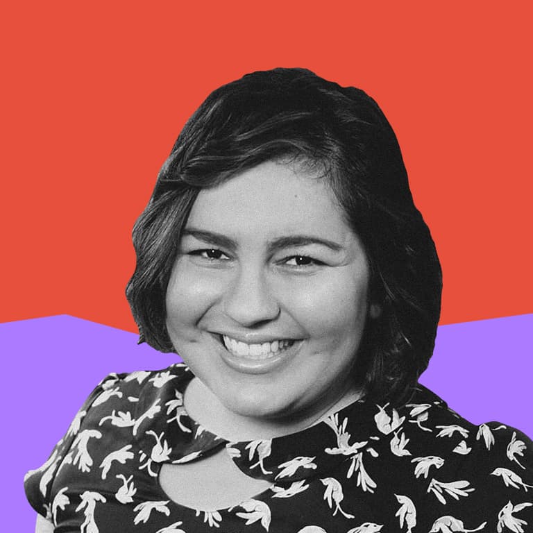 A smiling young Latina woman with wavy dark brown hair.